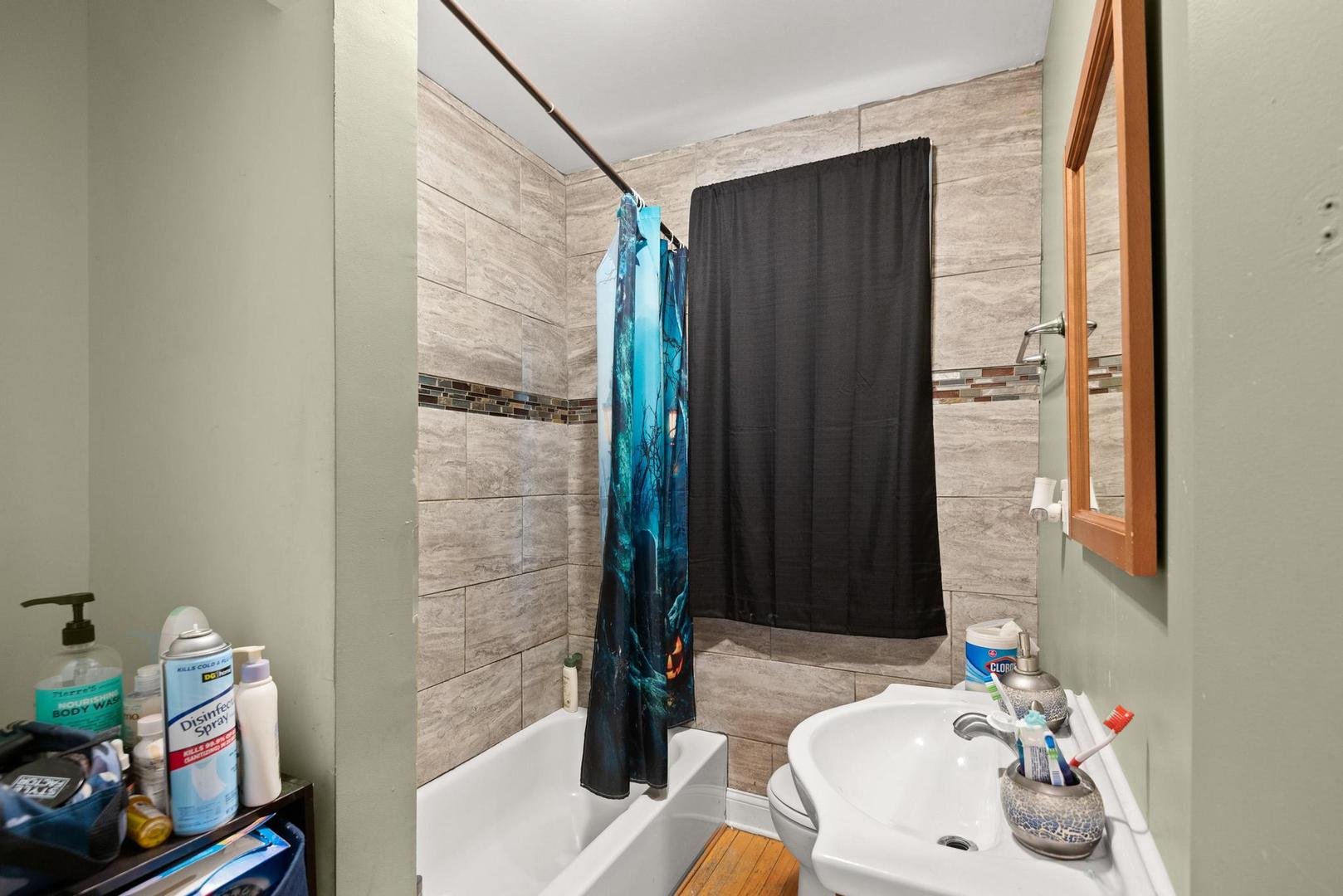 5941 West Chicago Avenue Chicago, IL 60651 - Photo 6 of 13 a bathroom with a sink and a mirror