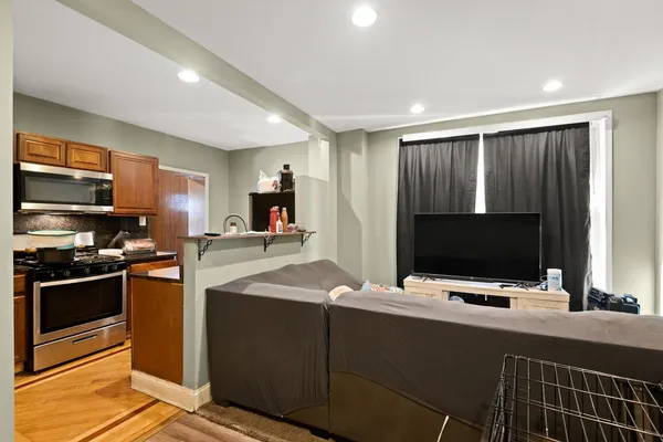 a kitchen with stainless steel appliances kitchen island granite countertop a stove and a microwave
