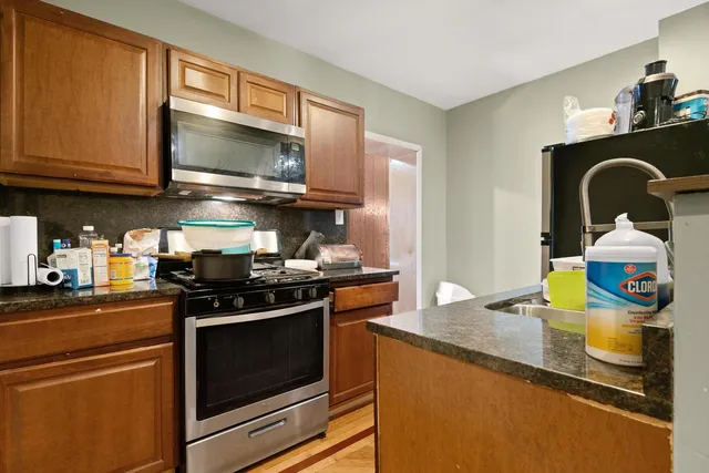 a kitchen with stainless steel appliances granite countertop a stove and a microwave