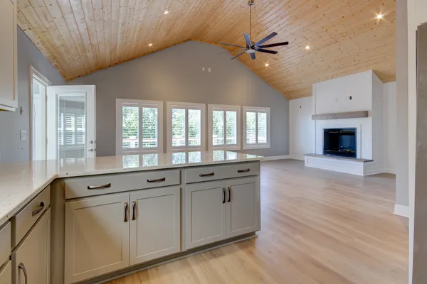 a spacious bathroom with a granite countertop sink a mirror and a shower