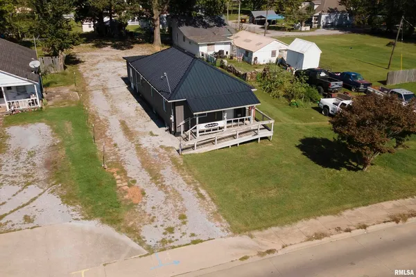 a aerial view of a house with a yard basket ball court and outdoor seating