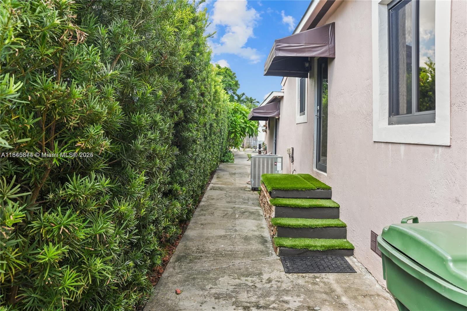 117 West 34th Street Hialeah, FL 33012 - Photo 19 of 27 a green field with some trees in front of main door