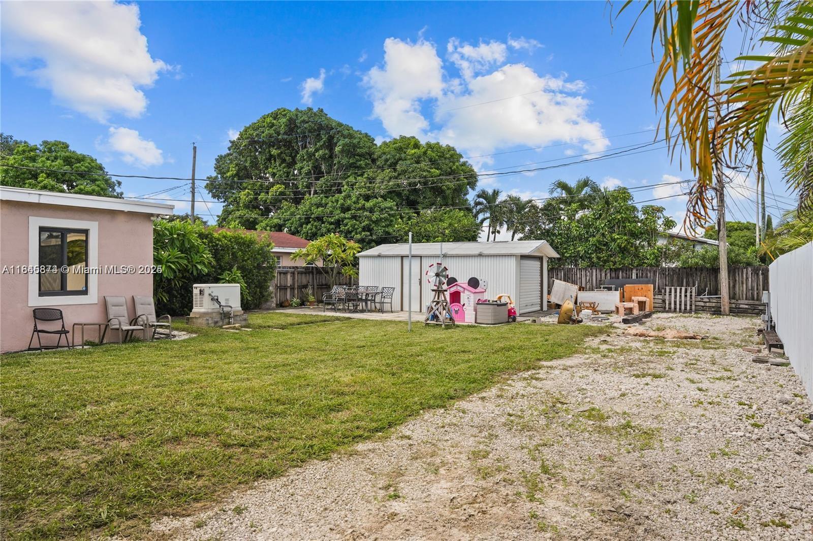 117 West 34th Street Hialeah, FL 33012 - Photo 21 of 27 a view of a house with a yard and a tree