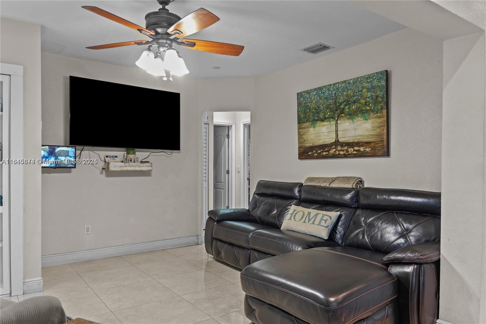 117 West 34th Street Hialeah, FL 33012 - Photo 5 of 27 a living room with furniture and a flat screen tv