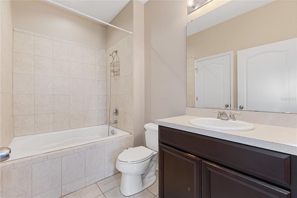 506 Rainbow Springs Loop Groveland, FL 34736 - Photo 12 of 30 a bathroom with a sink a toilet and shower