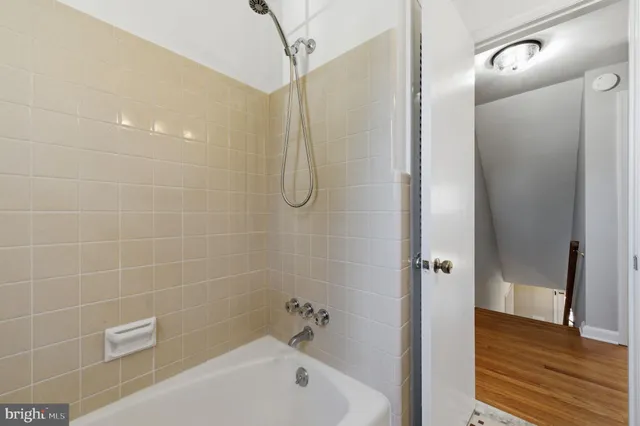 a bathroom with a bathtub and a shower