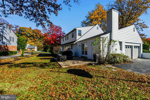 a view of a house with a yard and pathway