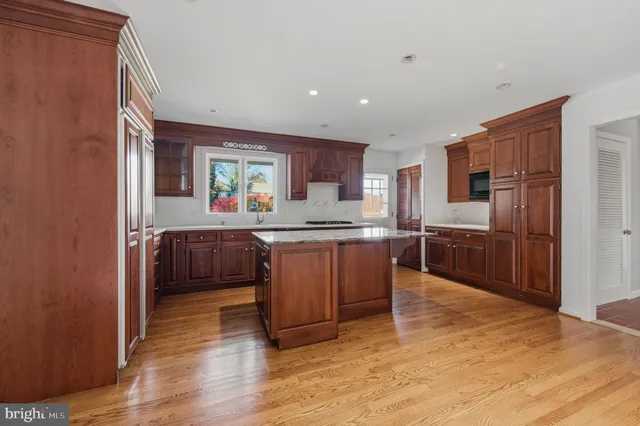 a kitchen with granite countertop a sink cabinets and stainless steel appliances
