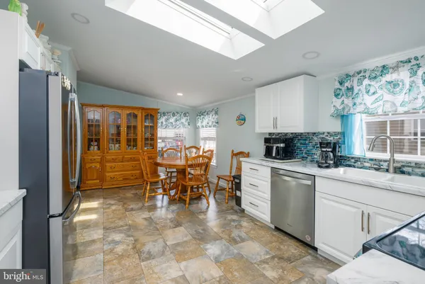 a kitchen with furniture and appliances