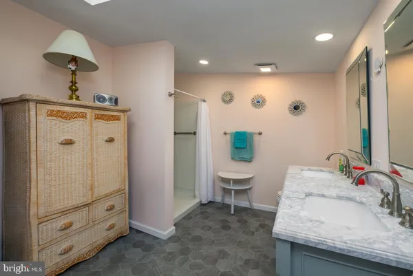a bathroom with a sink double vanity and a mirror