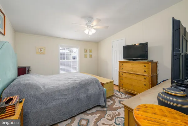 a bedroom with a bed and flat screen tv