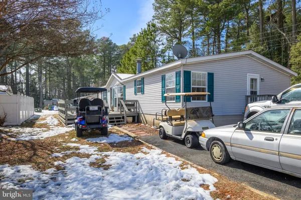 a view of a cars is parked in front of house