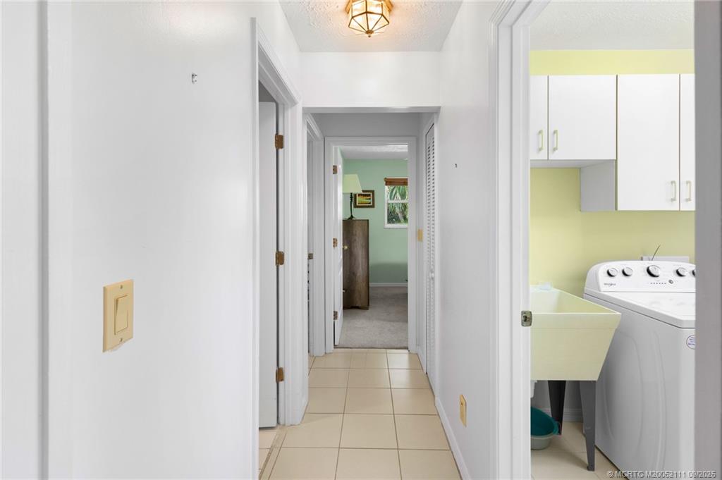 3418 Southeast Jamaica Way Stuart, FL 34997 - Photo 17 of 35 a view of hallway with washer and dryer
