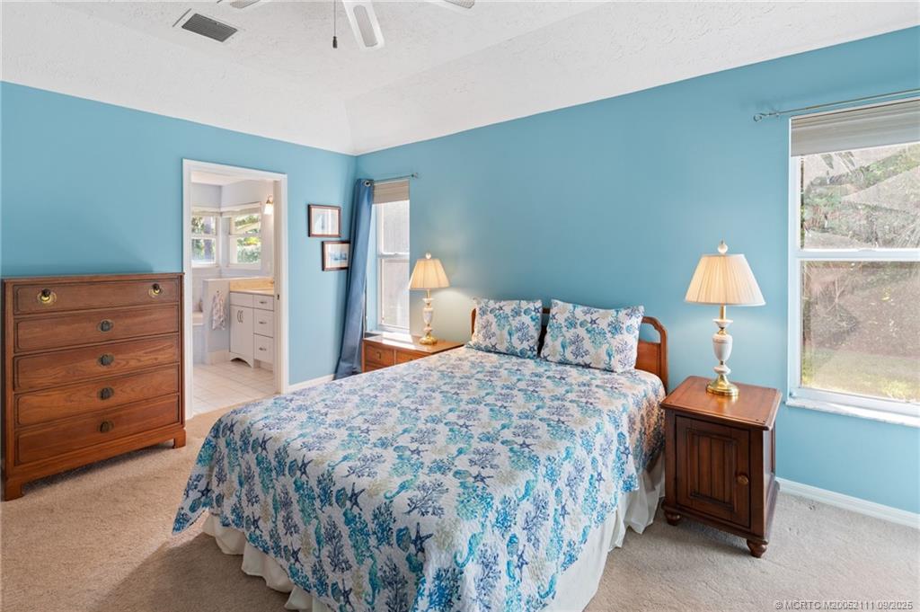 3418 Southeast Jamaica Way Stuart, FL 34997 - Photo 20 of 35 a bedroom with a bed and a dresser