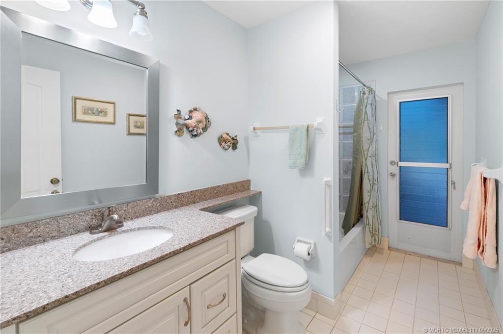 3418 Southeast Jamaica Way Stuart, FL 34997 - Photo 23 of 35 a bathroom with a granite countertop sink toilet and shower