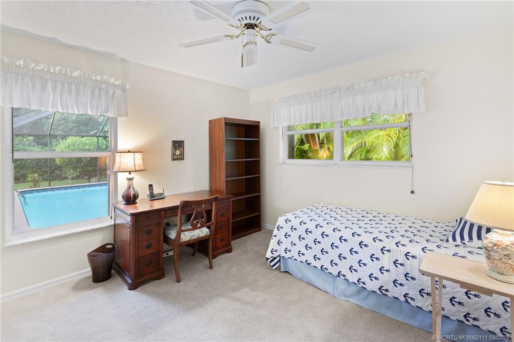 3418 Southeast Jamaica Way Stuart, FL 34997 - Photo 25 of 35 a bedroom with furniture and a window