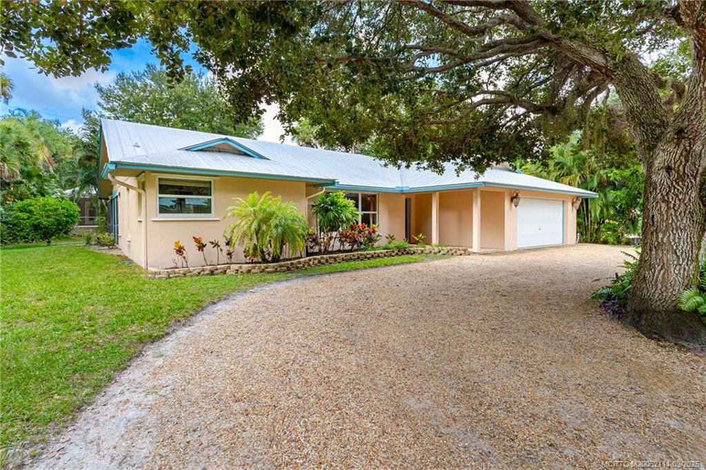 3418 Southeast Jamaica Way Stuart, FL 34997 - Photo 3 of 35 a front view of a house with garden