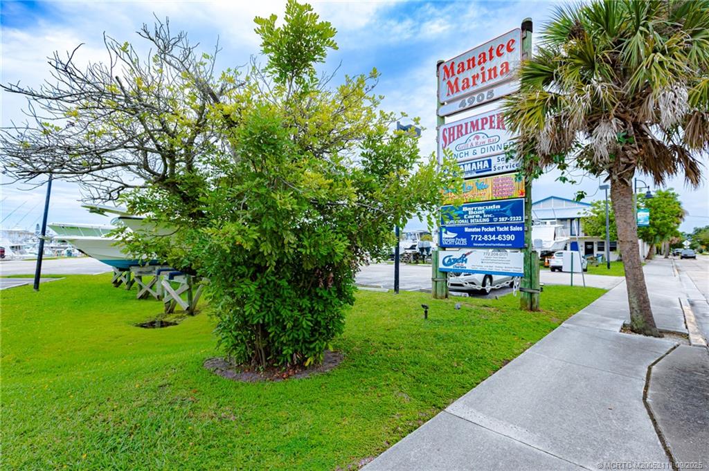 3418 Southeast Jamaica Way Stuart, FL 34997 - Photo 33 of 35 a sign that is sitting in the grass near a tree
