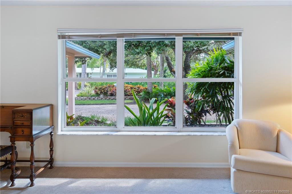 3418 Southeast Jamaica Way Stuart, FL 34997 - Photo 8 of 35 a living room with a couch and a window