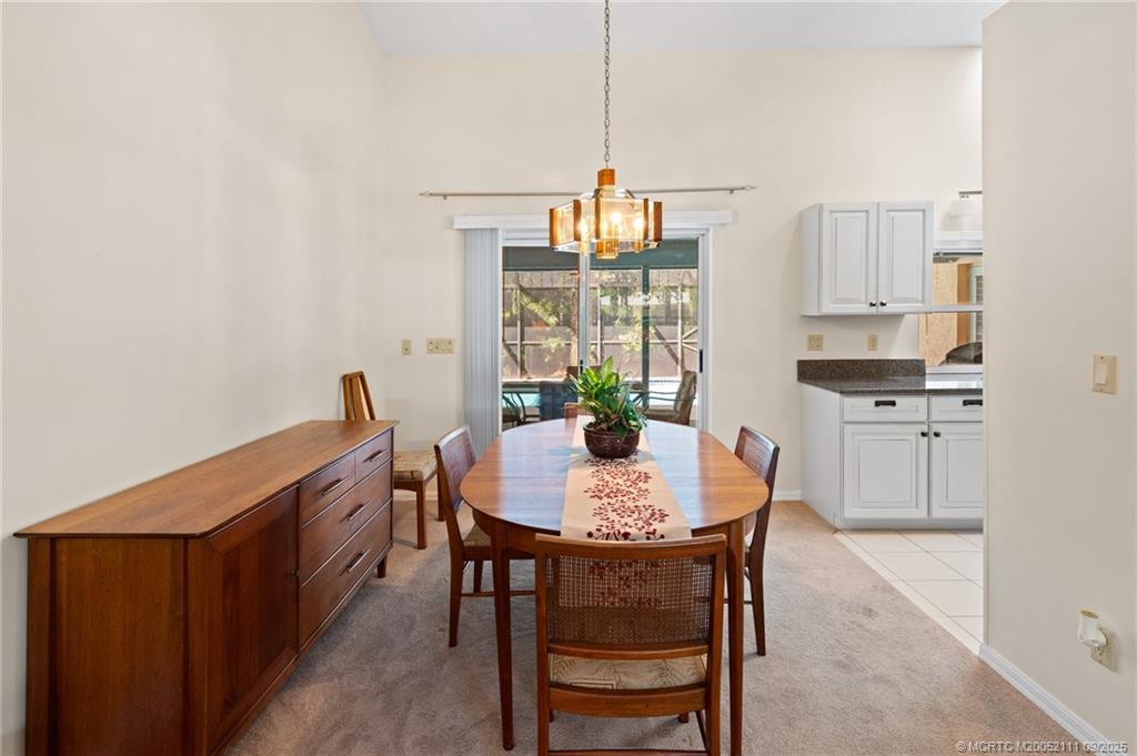 3418 Southeast Jamaica Way Stuart, FL 34997 - Photo 10 of 35 a dining room with furniture and window