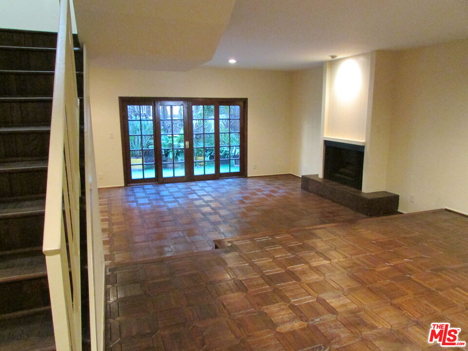 1850 Midvale Avenue, Unit 7 Los Angeles, CA 90025 - Photo 3 of 13 a view of an empty room with a fireplace and a window