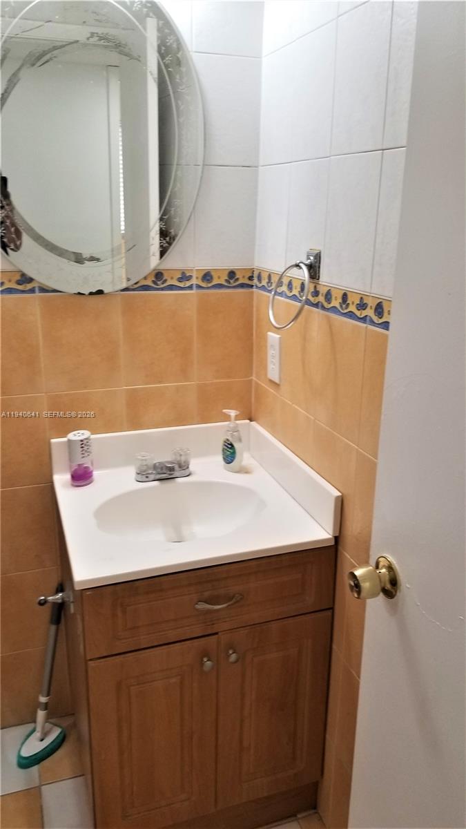 9723 Southwest 138th Avenue, Unit IA2L Miami, FL 33186 - Photo 13 of 27 a bathroom with a sink and a mirror