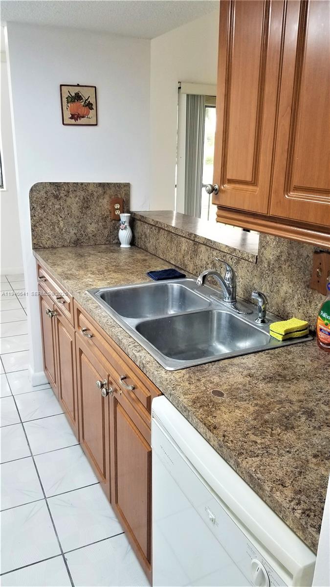 9723 Southwest 138th Avenue, Unit IA2L Miami, FL 33186 - Photo 19 of 27 a kitchen with sink and cabinets