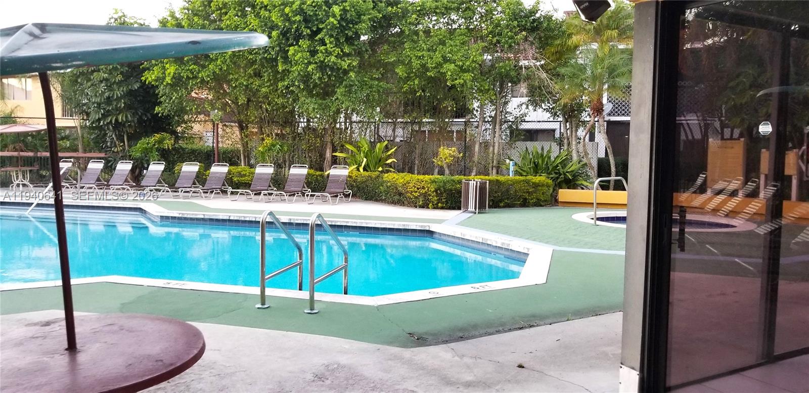 9723 Southwest 138th Avenue, Unit IA2L Miami, FL 33186 - Photo 27 of 27 a view of a swimming pool with a patio