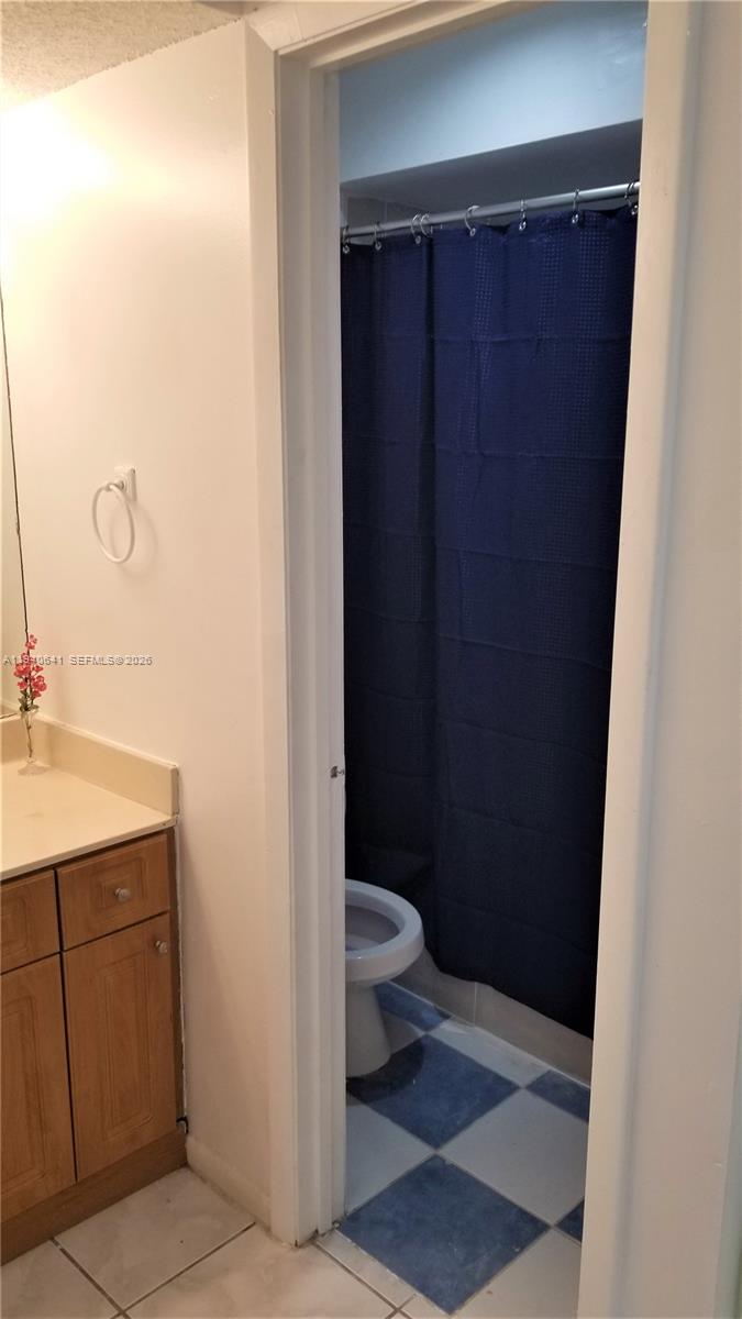 9723 Southwest 138th Avenue, Unit IA2L Miami, FL 33186 - Photo 8 of 27 a bathroom with a sink and a mirror