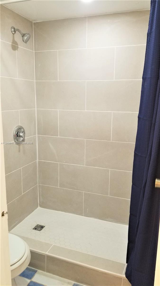 9723 Southwest 138th Avenue, Unit IA2L Miami, FL 33186 - Photo 9 of 27 a bathroom with a shower and a toilet