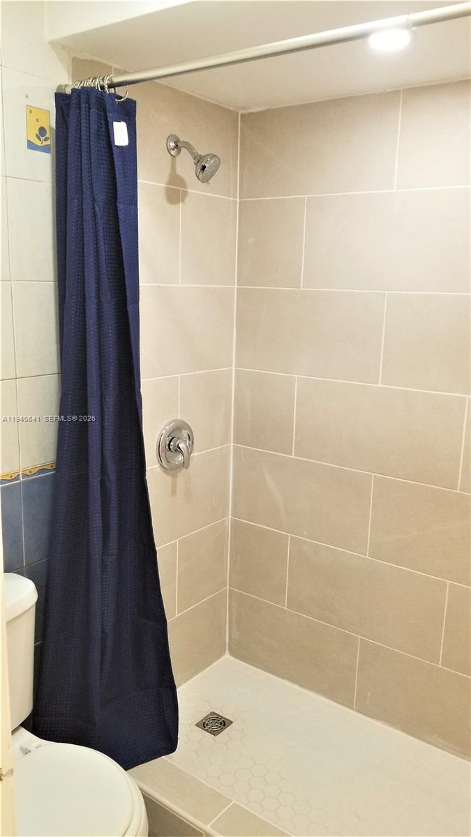 9723 Southwest 138th Avenue, Unit IA2L Miami, FL 33186 - Photo 10 of 27 a bathroom with a shower and a toilet