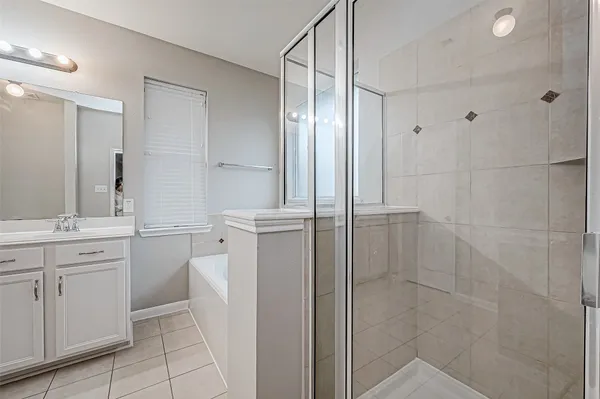 a bathroom with a double vanity sink a toilet and shower