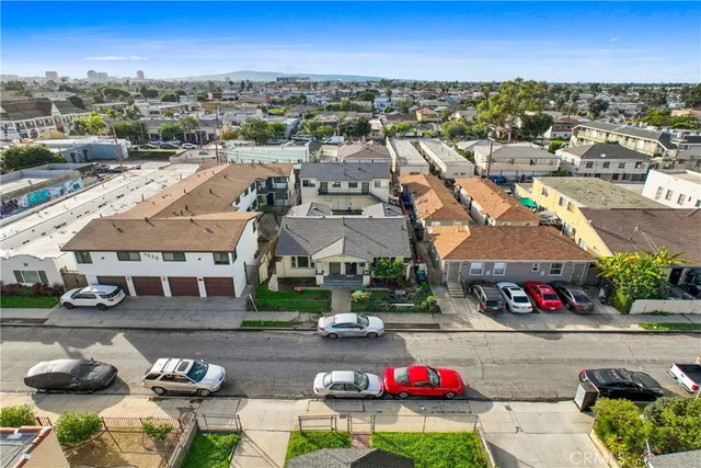 an aerial view of a building with cars parked