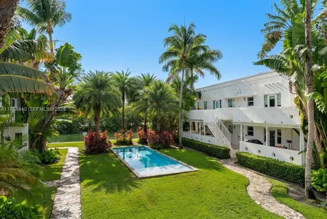 a view of house with yard and entertaining space