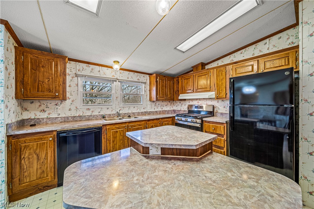 3471 Fox Road Kingsville, OH 44048 - Photo 13 of 50 Kitchen featuring sink, black appliances, a textured ceiling, and a center island