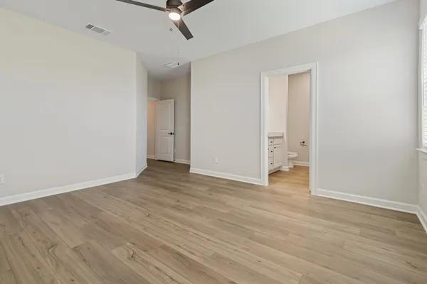 a view of a room with wooden floor and white walls