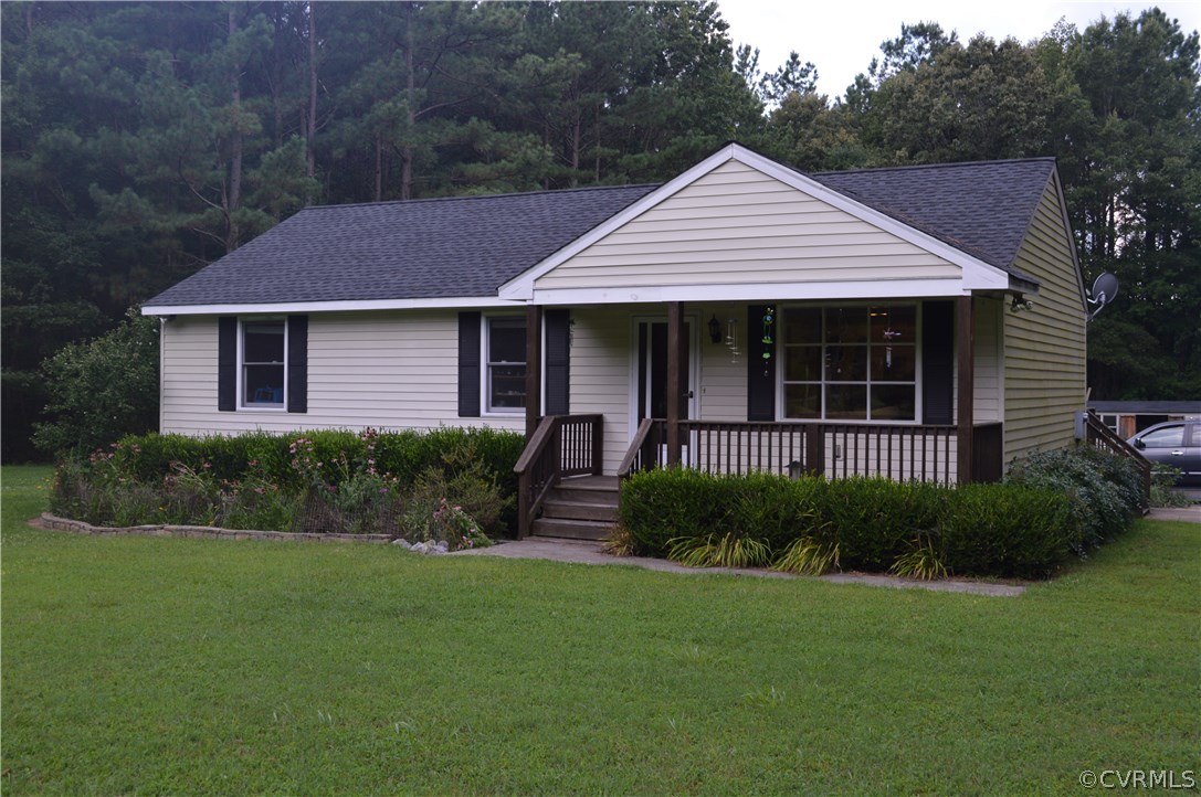 7308 Trinity Church Road Church Road, VA 23833 - Photo 1 of 37 a front view of a house with a garden