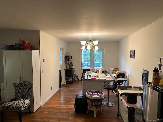 a view of a dining room with furniture and chandelier