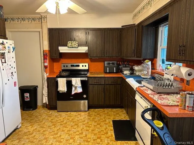 a kitchen with stainless steel appliances granite countertop a stove a sink and a refrigerator