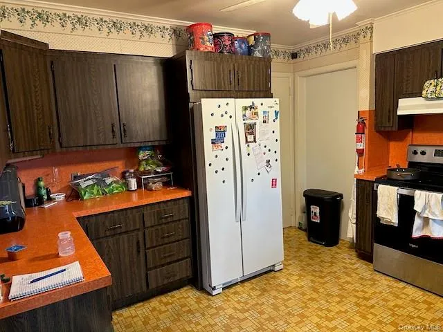 a kitchen with stainless steel appliances granite countertop a refrigerator and a stove top oven