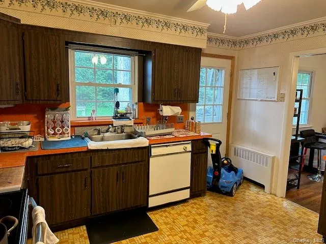 a kitchen with a sink refrigerator and cabinets
