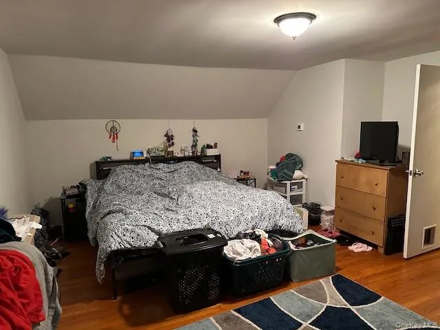 a bedroom with a bed and a tv