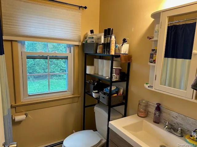 a bathroom with a sink mirror vanity and toilet