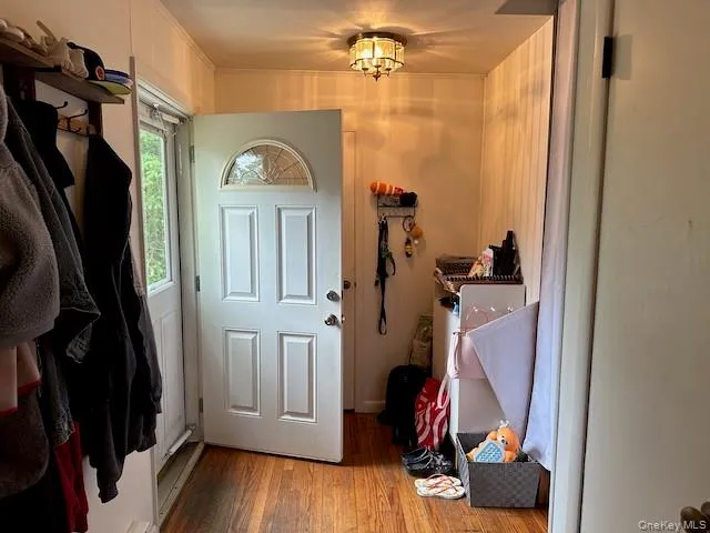 a view of a hallway with wooden floor and entryway