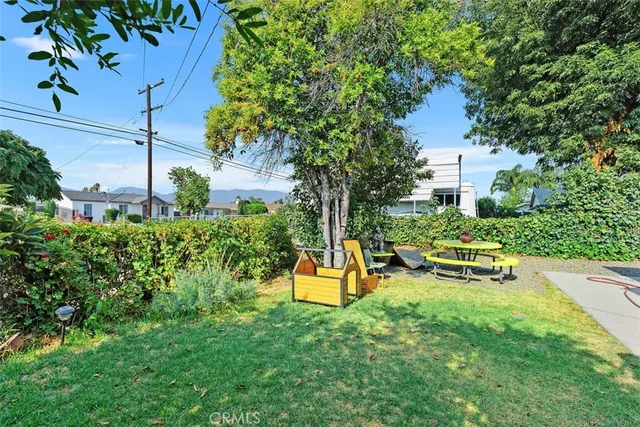 a garden with a bench and trees