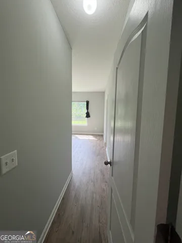 a view of a room with wooden floor