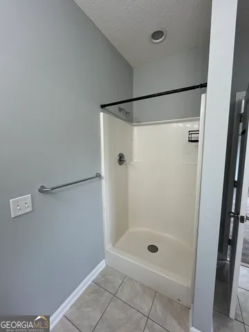 a bathroom with a glass shower door