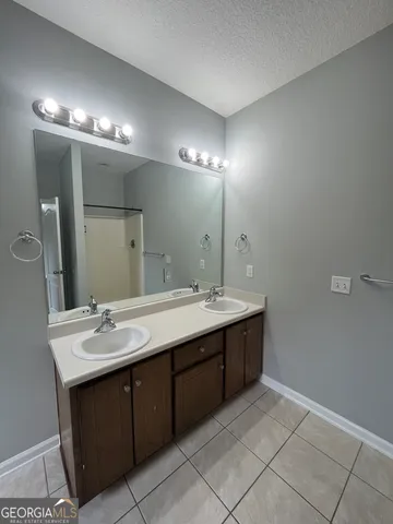 a bathroom with a sink vanity and a mirror