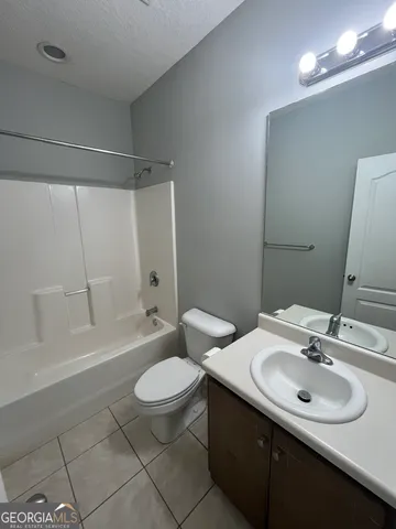 a bathroom with a sink toilet tub and shower