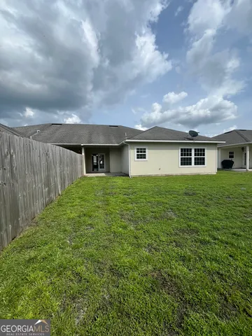 a view of a house with a backyard
